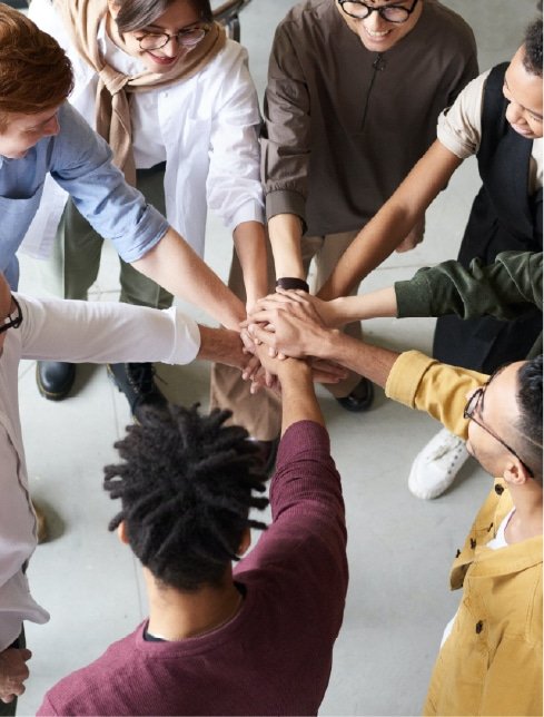 A team putting their hands together in a circle